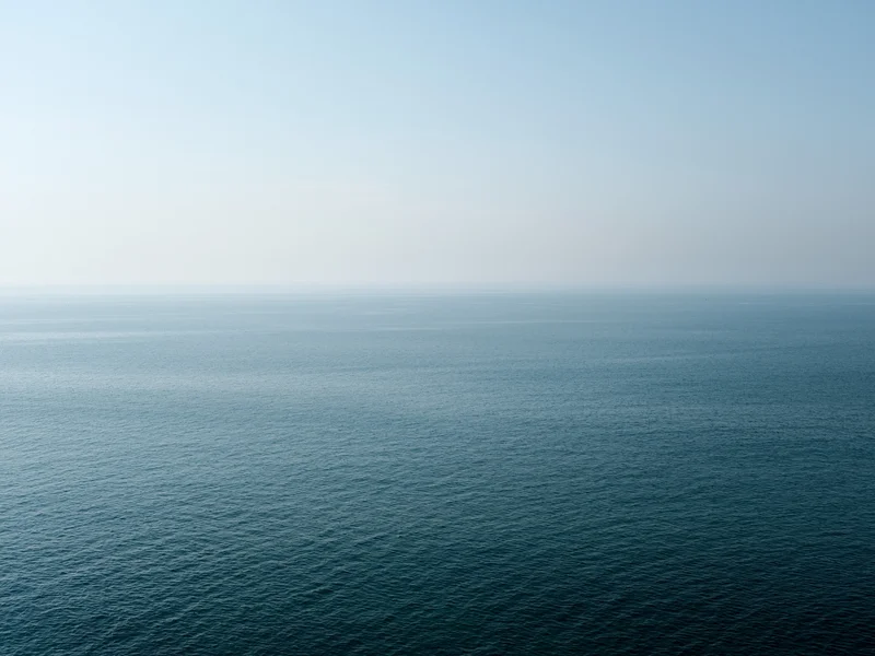 Calm ocean view under a clear sky.